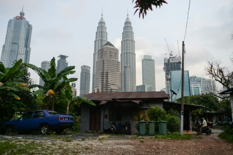 In the shadow of Kuala Lumpur's mammoth Petronas Towers lies an urban anomaly: the rustic ethnic-Malay enclave of Kampung Baru, where chickens and barefoot children dart across streets