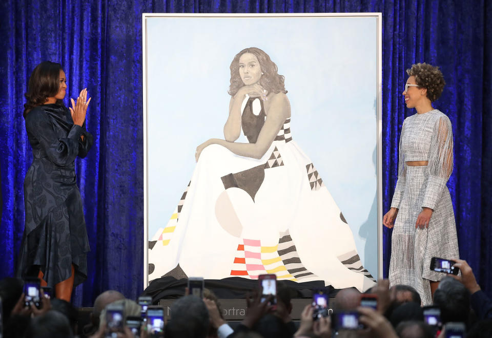 Former U.S. first lady Michelle Obama and artist Amy Sherald unveil Obama's portrait during a ceremony at the Smithsonian's National Portrait Gallery on Feb. 12, 2018. (Photo: Mark Wilson via Getty Images)