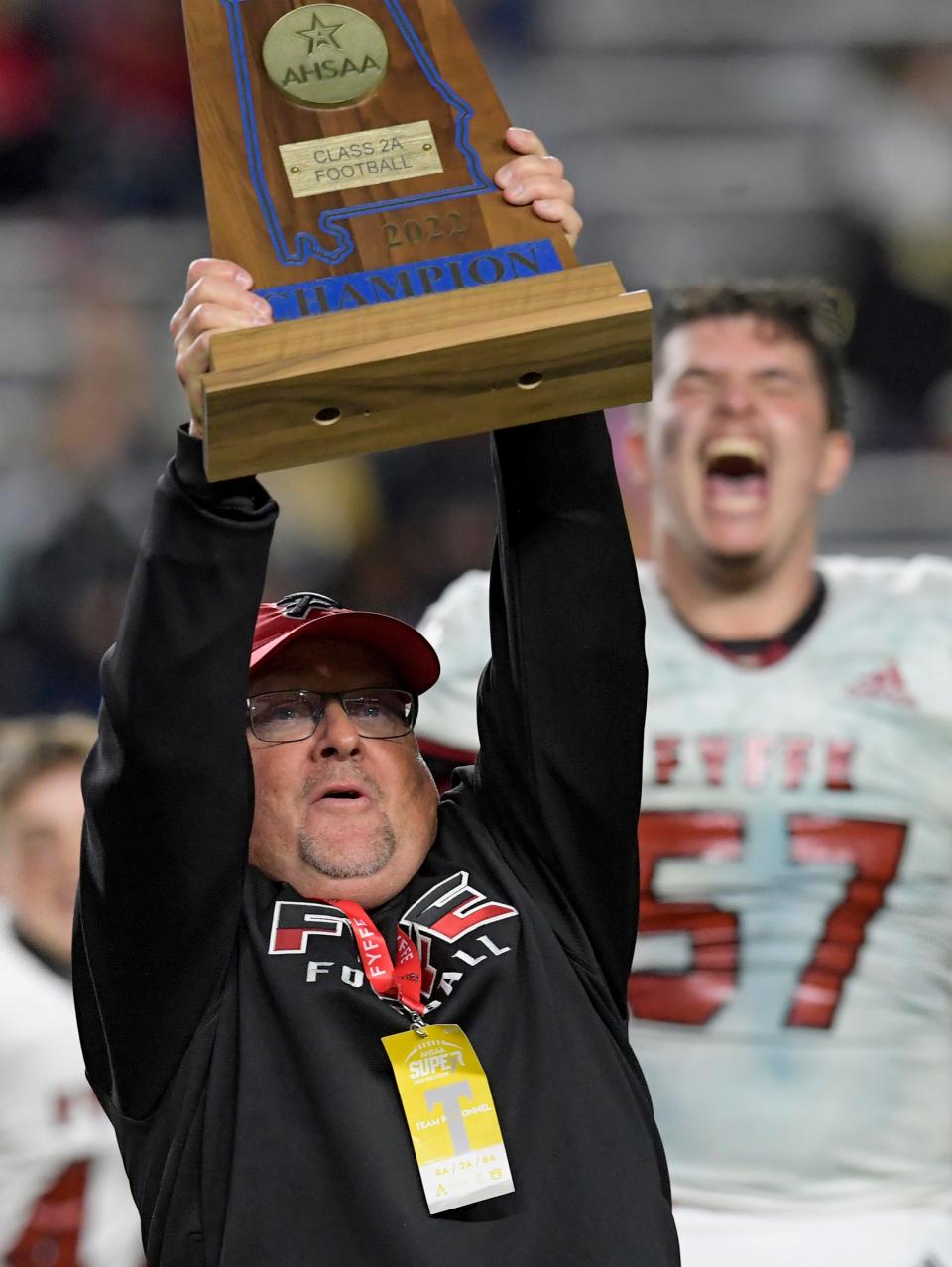 Fyffe coach Paul Benefield hoists the trophy after his team defeated B.B. Comer in the AHSAA Class 2A State Football Championship Game at Jordan Hare Stadium in Auburn, Ala., on Friday December 2, 2022.