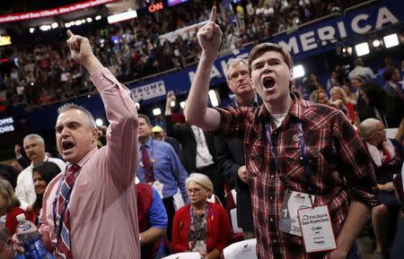 Delegates yell after the temporary chairman of the Republican National Convention announced that the convention would not hold a roll-call vote on the Rules Committee's report and rules changes and rejected the efforts of anti-Trump forces to hold such a vote at the Republican National Convention in Cleveland, Ohio, U.S. July 18, 2016. REUTERS/Mark Kauzlarich