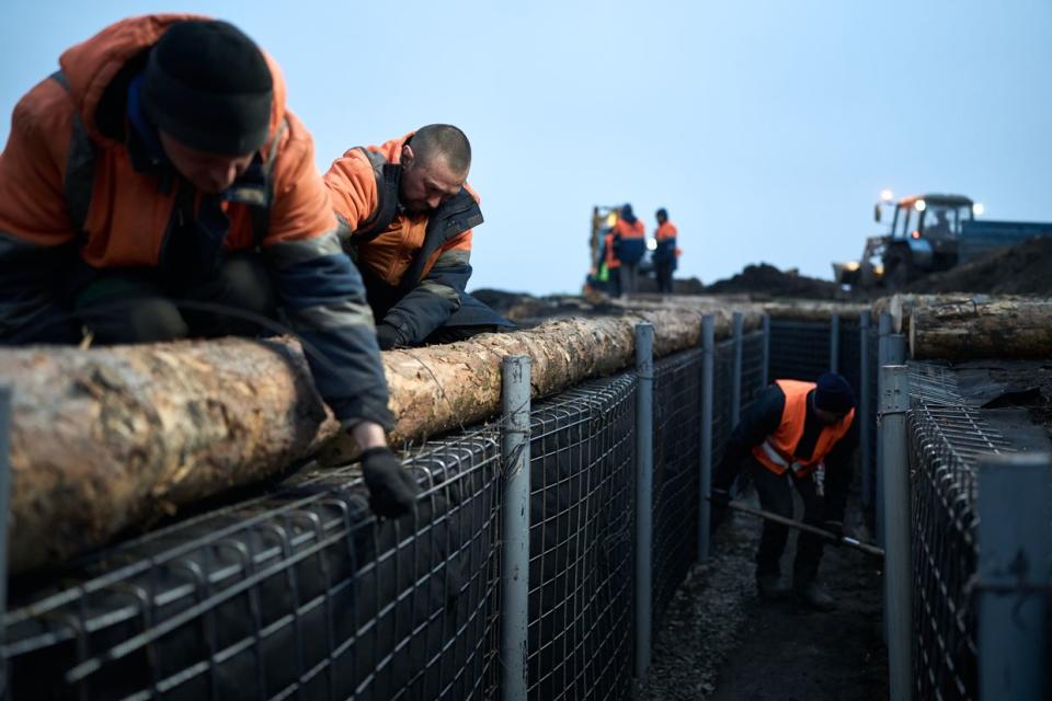 Representatives of the Regional Administration and the construction contractor Avtomagistral-pivden LLC inspect the fortifications being built in Sumy Oblast, Ukraine on March 16, 2024. (Kostiantyn Liberov/ Libkos/Getty Images)