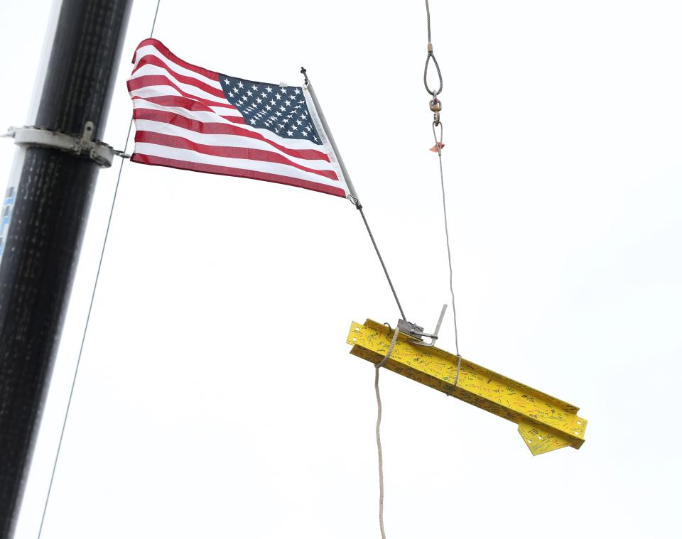 The final steel girder for the Food Bank of the Hudson Valley's new building in Montgomery is hoisted into position on March 7, 2024 during their topping out ceremony.