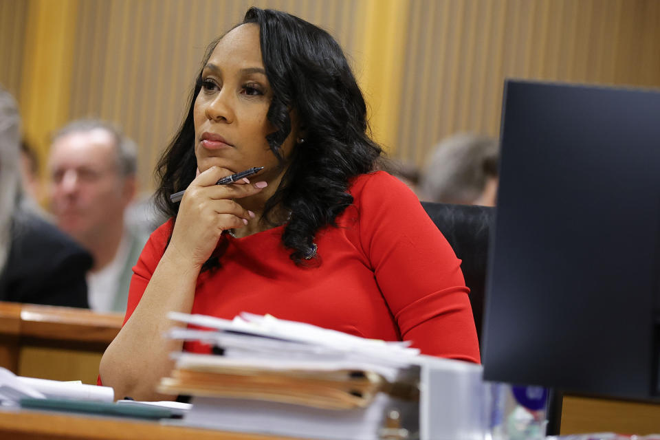 FILE - Fulton County District Attorney Fani Willis looks on during a hearing on the Georgia election interference case, Friday, March, 1, 2024, in Atlanta. On Wednesday, March 6, Ashleigh Merchant, the lawyer who initiated the effort to remove Willis from the Georgia election interference case against former President Donald Trump, walked state lawmakers through her investigation into the Willis' romantic relationship with a special prosecutor and why she believes it creates a conflict of interest. (AP Photo/Alex Slitz, Pool, File)