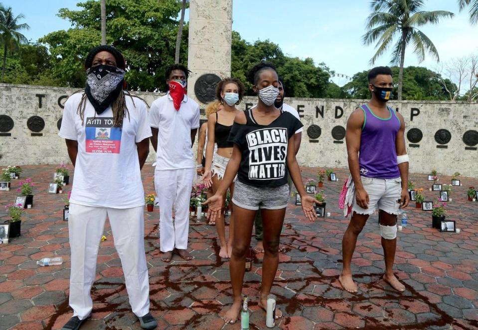 A small group of protestors honor all victims of police brutality during a protest called “Say Their Names” at the Friendship Torch on Biscayne Boulevard in Miami on Saturday July 4.