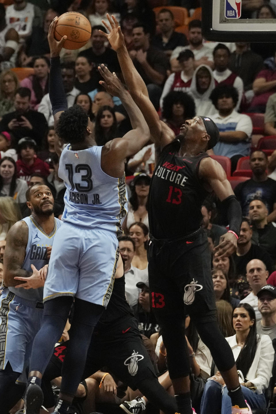 Memphis Grizzlies forward Jaren Jackson Jr. (13) drives to the basket as Miami Heat center Bam Adebayo (13) defends during the first half of an NBA basketball game, Wednesday, Jan. 24, 2024, in Miami. (AP Photo/Marta Lavandier)