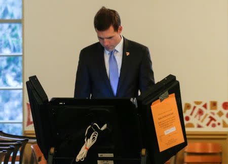 FILE PHOTO: Democratic congressional candidate Conor Lamb fills out his ballot on a voting machine in Mt. Lebanon, Pennsylvania, U.S., March 13, 2018. REUTERS/Brendan McDermid/File Photo