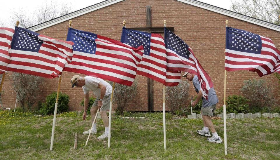 Bob Butler, left, and Bob Gordon, right, work or a memorial at Central Christian Church for the victims of a Fort Hood shooting, Thursday, April 3, 2014, in Killeen, Texas. A soldier, Spc. Ivan Lopez, opened fire Wednesday on fellow service members at the Fort Hood military base, killing three people and wounding 16 before committing suicide. (AP Photo/Eric Gay)