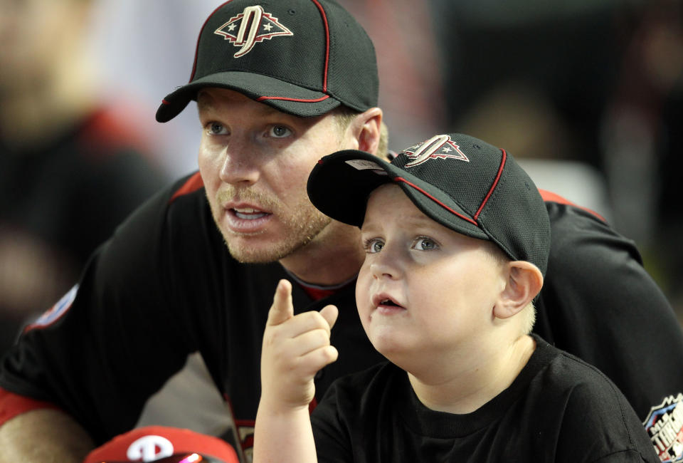 National League All-Star Roy Halladay looks on with his son Ryan during the 2011 State Farm Home Run Derby on July 11, 2011.