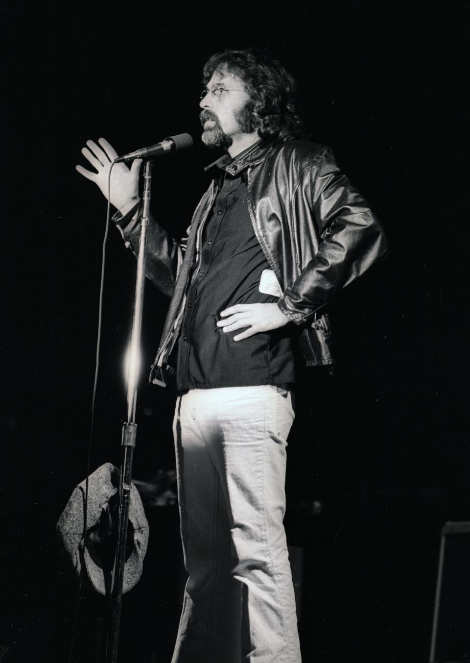 DJ Bob Reitman, emcee at the Bruce Springsteen concert on Oct. 2, 1975, at the Uptown Theater, speaks to the crowd after a bomb threat was called in, forcing an evacuation and temporary suspension of the show.