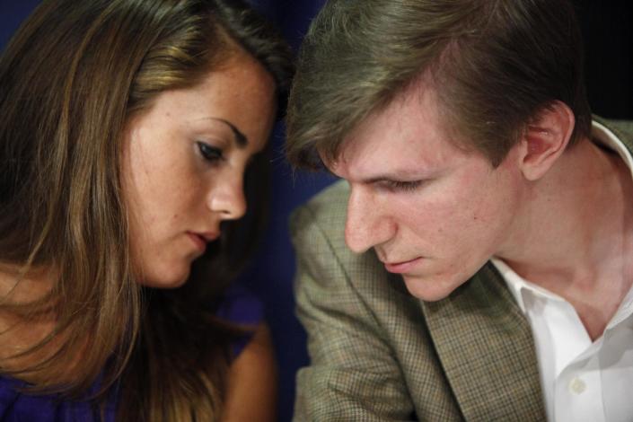This October 2009 file photo shows Hannah Giles, left, talking with James O'Keefe III during a news conference at the National Press Club in Washington. The conservative activist whose hidden camera videos led to the downfall of the community group ACORN has settled a lawsuit with a former ACORN employee who appeared in them. In documents filed in a San Diego court, James O’Keefe agreed to pay Juan Carlos Vera $100,000 and apologized for any pain Vera suffered. (AP Photo/Haraz N. Ghanbari, file)