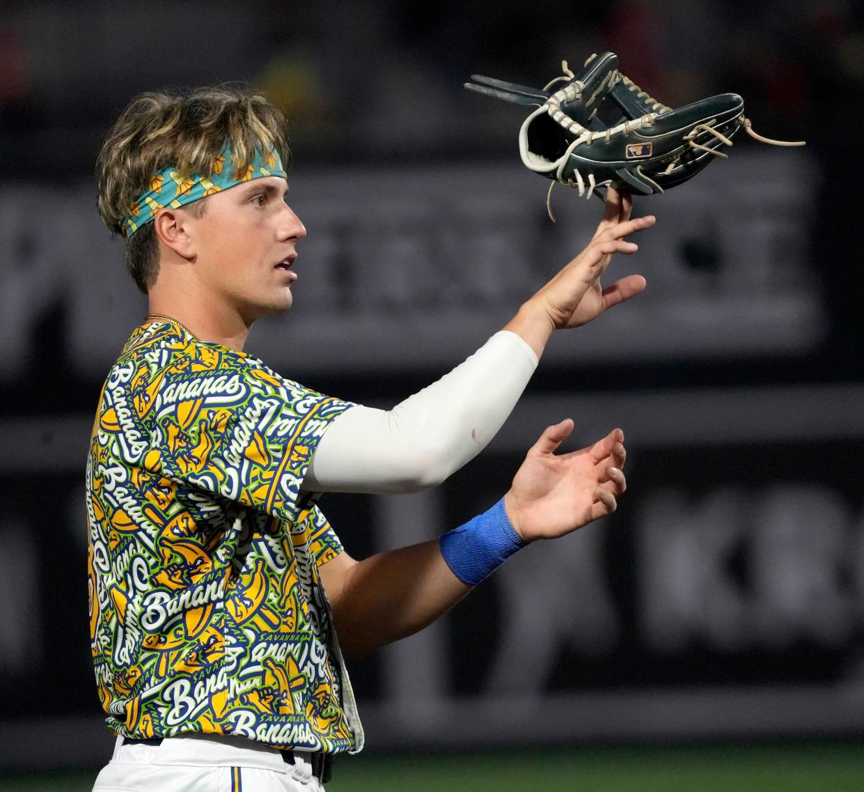 The Savannah Bananas Jackson Olson (8) balances his glove on his hand during the exhibition baseball game against the Party Animals at Franklin Field in Franklin on Friday, Sept. 8, 2023.