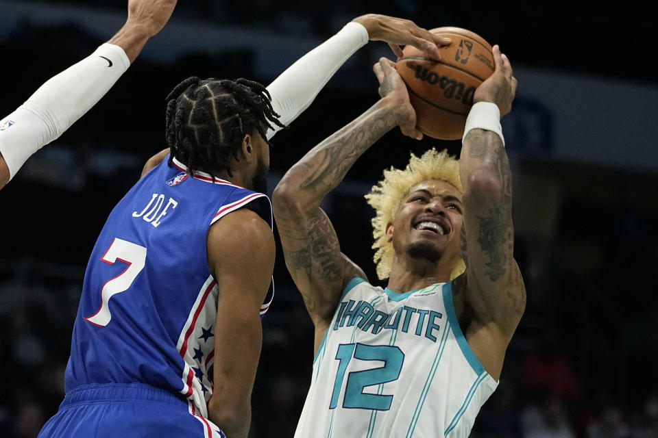 Philadelphia 76ers guard Isaiah Joe blocks a shot by Charlotte Hornets guard Kelly Oubre Jr. during the first half of an NBA basketball game on Monday, Dec. 6, 2021, in Charlotte, N.C. (AP Photo/Chris Carlson)