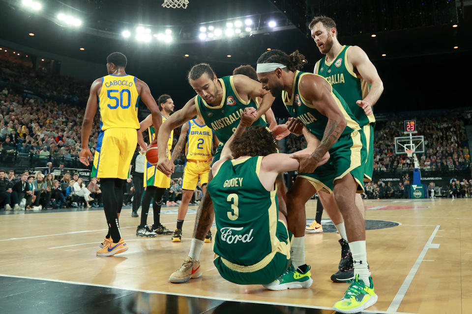 MELBOURNE, AUSTRALIA – AUGUST 16: <a class="link " href="https://sports.yahoo.com/nba/players/10058" data-i13n="sec:content-canvas;subsec:anchor_text;elm:context_link" data-ylk="slk:Xavier Cooks;sec:content-canvas;subsec:anchor_text;elm:context_link;itc:0">Xavier Cooks</a>, Josh Giddey and <a class="link " href="https://sports.yahoo.com/nba/players/4660" data-i13n="sec:content-canvas;subsec:anchor_text;elm:context_link" data-ylk="slk:Patty Mills;sec:content-canvas;subsec:anchor_text;elm:context_link;itc:0">Patty Mills</a> of Australia react during the match between the Australia Boomers and Brazil at Rod Laver Arena on August 16, 2023 in Melbourne, Australia. (Photo by Kelly Defina/Getty Images)