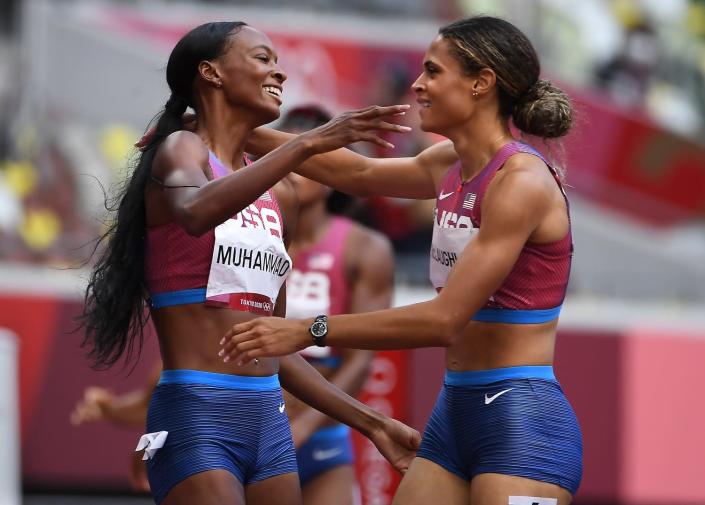 Sydney McLaughlin and Dalilah Muhammed embrace on the track at the Tokyo Olympics.