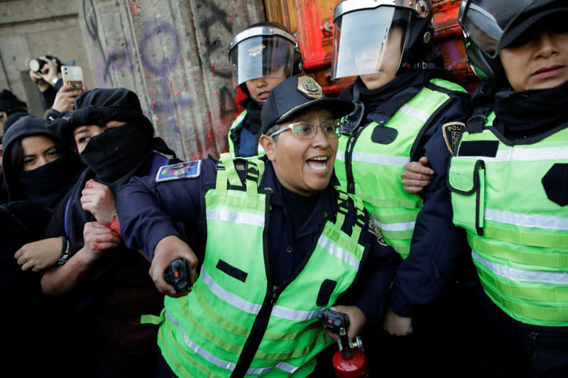 People take part in a protest against gender-based violence in downtown of Mexico City