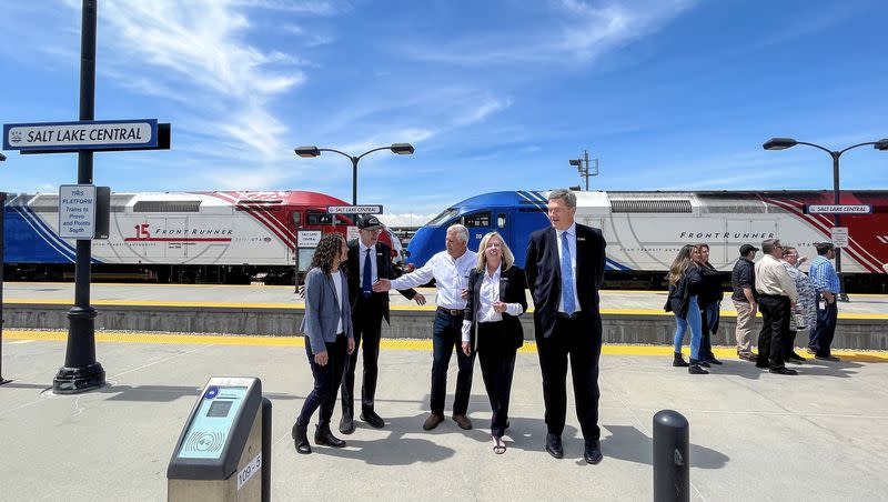 Utah Transit Authority Executive Director Jay Fox, second from left, and other UTA and UDOT officials with two parked FrontRunner trains at Salt Lake Central Station on Wednesday. UTA celebrated FrontRunner’s 15th anniversary.
