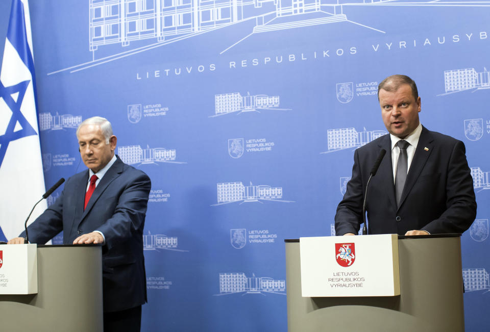 Lithuania's Prime Minister Saulius Skvernelis, right, speaks as Israel's Prime Minister Benjamin Netanyahu, left, listens during a news conference at the government's headquarters in Vilnius, Lithuania, Thursday, Aug. 23, 2018. Netanyahu arrived in Lithuania Thursday for a four-day visit during which he will also meet his Latvian and Estonian counterparts, local officials and the Jewish community. (AP Photo/Mindaugas Kulbis)
