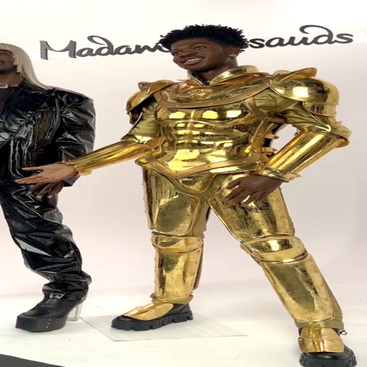 Wax figure in a gold metallic suit