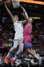 Miami Heat forward Nikola Jovic (5) goes up for a shot against Washington Wizards forward Corey Kispert (24) during the first half of an NBA basketball game, Friday, Nov. 25, 2022, in Miami. (AP Photo/Wilfredo Lee)