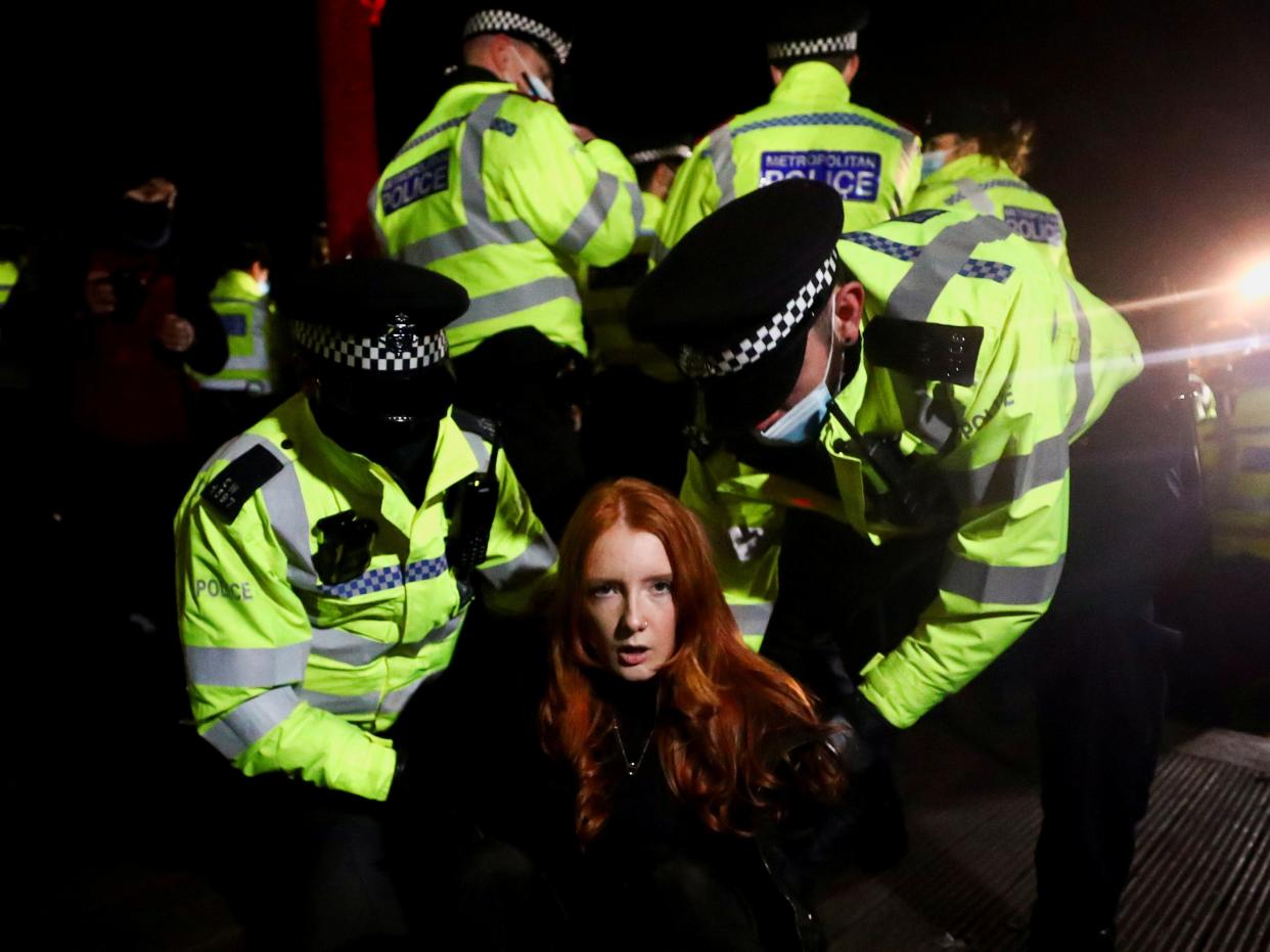 <p>Police detain Patsy Stevenson at a memorial site in Clapham Common</p> (Reuters)