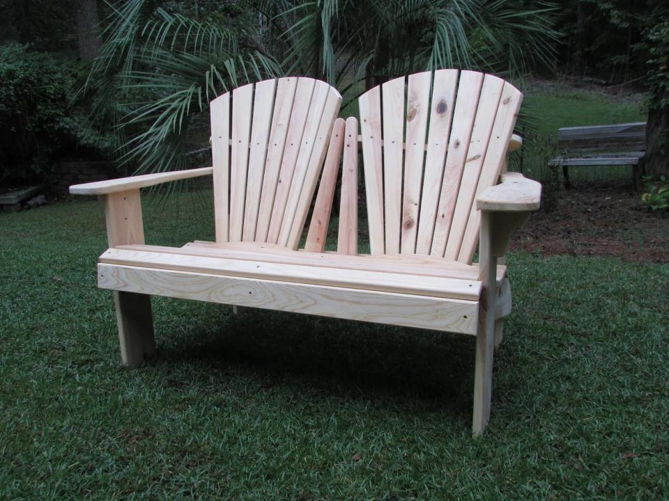 Wood Adirondack-style loveseat bench outdoors