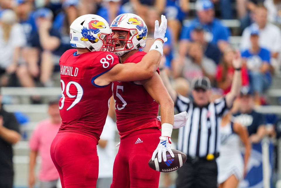 Kansas football tight end Trevor Kardell (45) celebrates with tight end Mason Fairchild (89) after scoring a touchdown during the first half of a game against BYU on Sept. 23, 2023 in Lawrence.