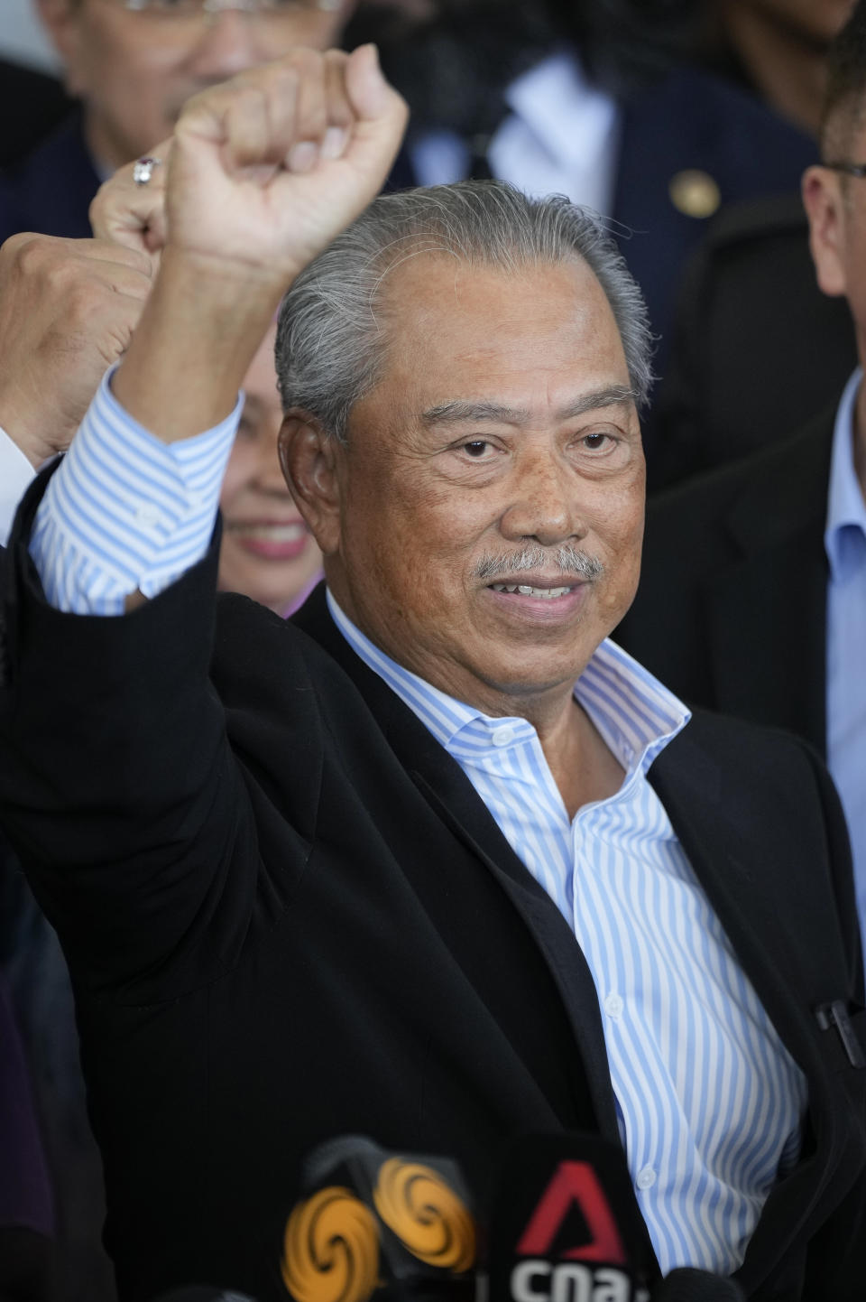 Malaysia's former Prime Minister Muhyiddin Yassin poses for media outside courthouse, after charged with corruption and money laundering, in Kuala Lumpur, Malaysia, Friday, March 10, 2023. Muhyiddin has been charged with corruption and money laundering, making him Malaysia's second ex-leader to be indicted after leaving office. Muhyiddin pleaded innocent Friday to four charges of corruption and two charges of money laundering. (AP Photo/Vincent Thian)