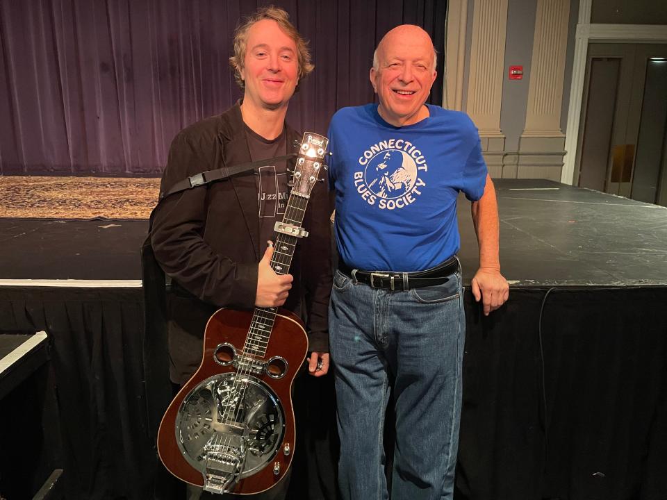 Blues guitarist James Limerick Kerr and Norwich Arts Center Treasurer Ron Bates. Kerr will have a show at the Donald L. Oat Theater on Jan 8., to fundraise for his trip representing Connecticut in the International Blues Challenge.