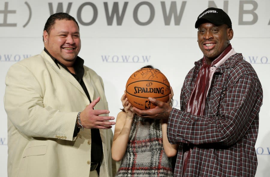 FILE – Former NBA basketball player Dennis Rodman, right, former sumo grand champion Akebono, left, and Japanese actress Maomi Yuki pose for photographers during a news conference to promote a TV program in Tokyo, on Oct. 25, 2013. Hawaii-born Akebono, one of the greats of sumo wresting and a former grand champion, is reported to have died earlier this month of heart failure while receiving care at a hospital in Tokyo, the United States Forces in Japan said in a statement on Thursday, April 11, 2024. (AP Photo/Shizuo Kambayashi, File)