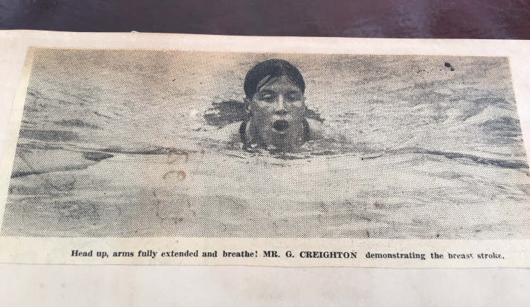 George Creighton showing a photo in his scrapbook of him swimming in his younger days. (Photo: Amritpal Khaira/Yahoo Singapore)