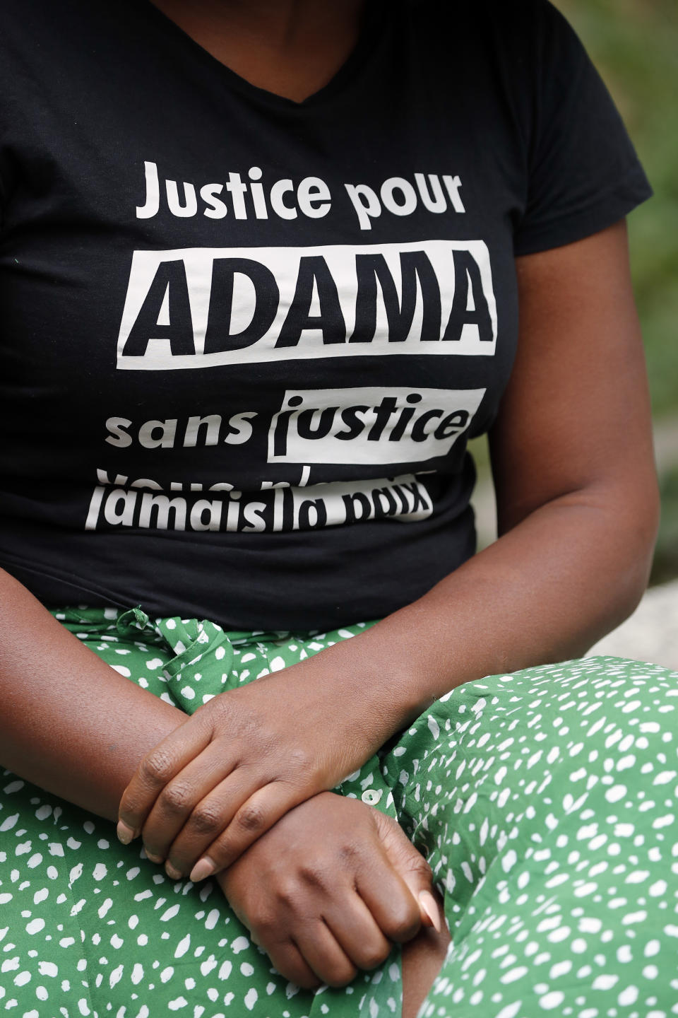 Assa Traore, wearing a shirt that reads: “Justice for Adama, without Justice you will never be in Peace,” attends an interview in Ivry-sur-Seine, on the outskirts of Paris, Wednesday, July 15, 2020. Traore started by fighting for justice for her brother Adama, who died in police custody on his 24th birthday four years ago. She’s now at the forefront of a new movement for Black rights in France that aims to wipe out systemic racism in policing and challenge the country’s official vision of itself as a colorblind society. (AP Photo/Francois Mori)