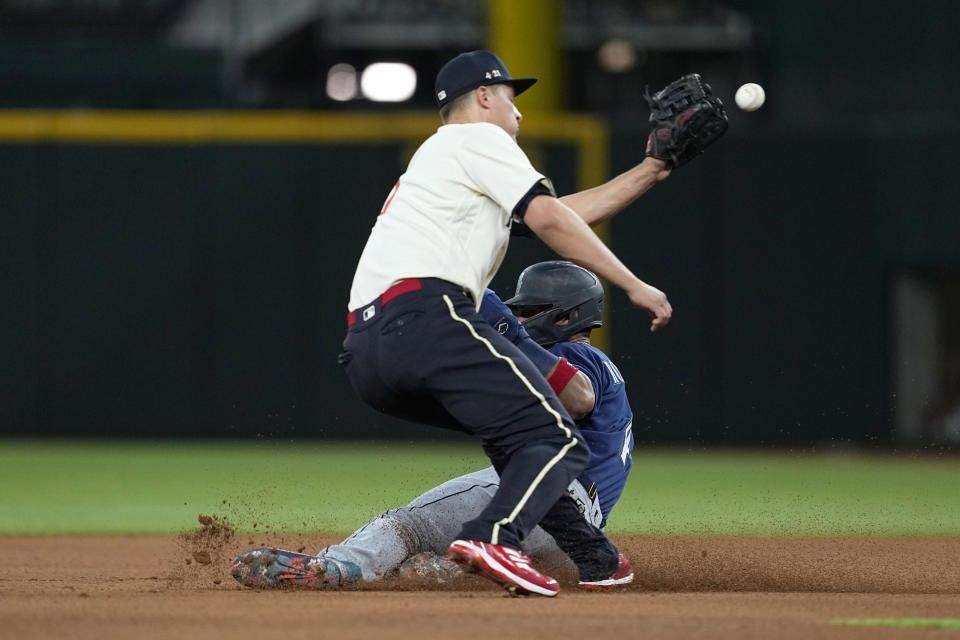 Texas Rangers shortstop Corey Seager reaches for the throw as Seattle Mariners' Julio Rodriguez steals second base during the fourth inning of a baseball game Friday, June 2, 2023, in Arlington, Texas. (AP Photo/Tony Gutierrez)