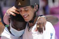 Cory Juneau of the United States is greeted by Zion Wright of the United States during the men's park skateboarding finals at the 2020 Summer Olympics, Thursday, Aug. 5, 2021, in Tokyo, Japan. (AP Photo/Ben Curtis)