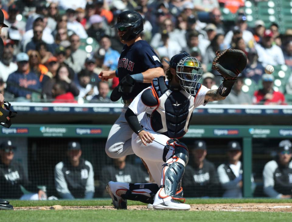 Boston Red Sox shortstop Enrique Hernandez (5) scores ahead of the tag by Detroit Tigers catcher Eric Haase (13) during the second inning at Comerica Park in Detroit on Sunday, April 9, 2023.
