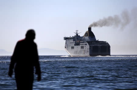 A man looks at a ferry departing from the western Greek town of Patras May 4, 2015. REUTERS/Yannis Behrakis