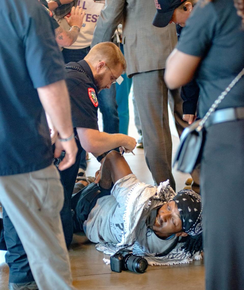 Police detain a protester on the ninth floor of The Dillon in Raleigh, N.C., Thursday, May 23, 2024. The protesters were demonstrating against the UNC Board of Governors DEI vote.