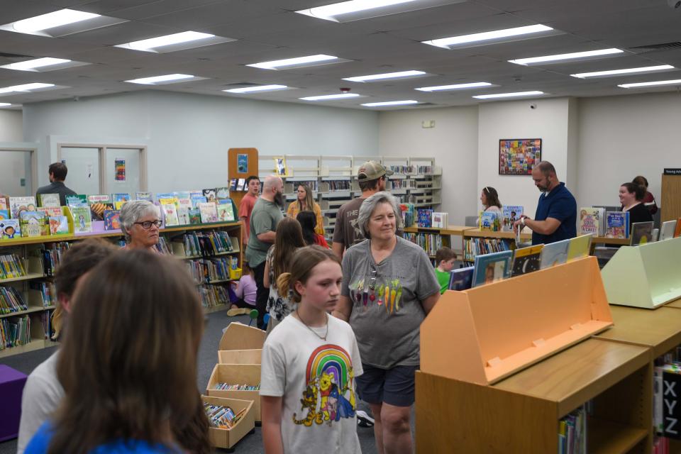 Attendees survey the inside of the newly reinnovated Chester County Library in Henderson, Tenn., on Tuesday, April 30, 2024.