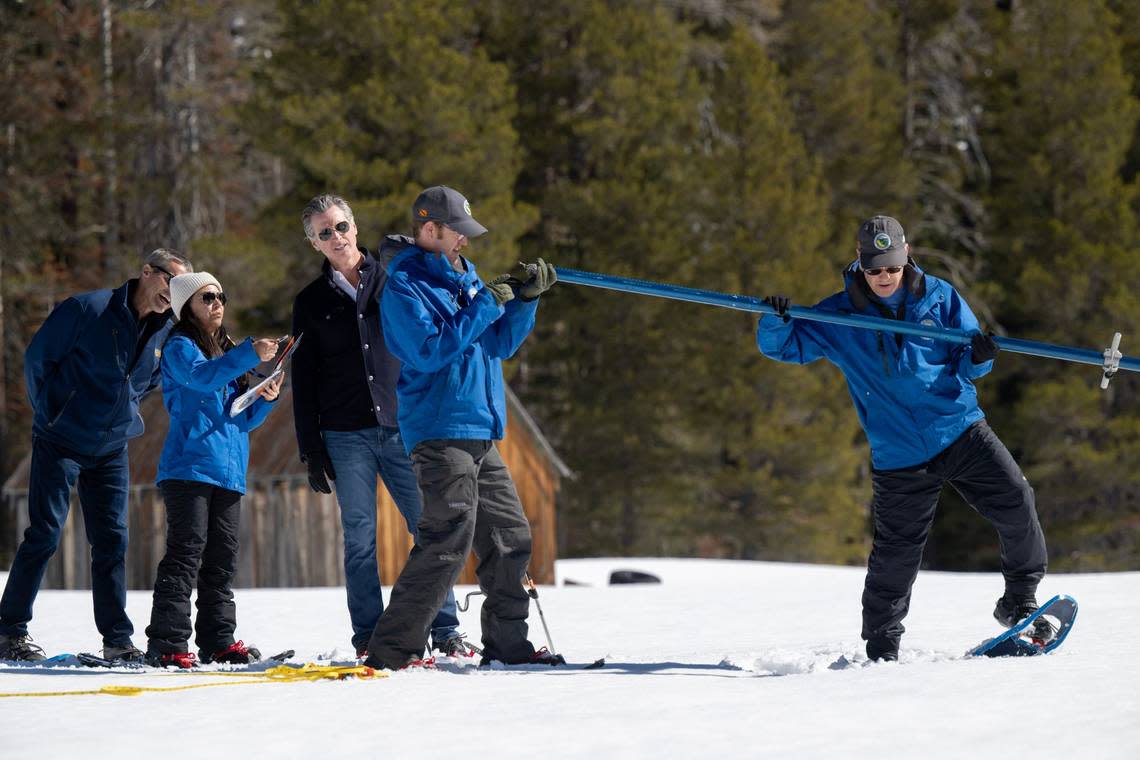 Gov. Gavin Newsom watches the Department of Water Resources team performs its April snow survey at Phillips Station in El Dorado County on Tuesday, April 2, 2024. The measurement of the April water content in the snowpack is 110% of normal and is a key indicator for future water supply. Paul Kitagaki Jr./pkitagaki@sacbee.com