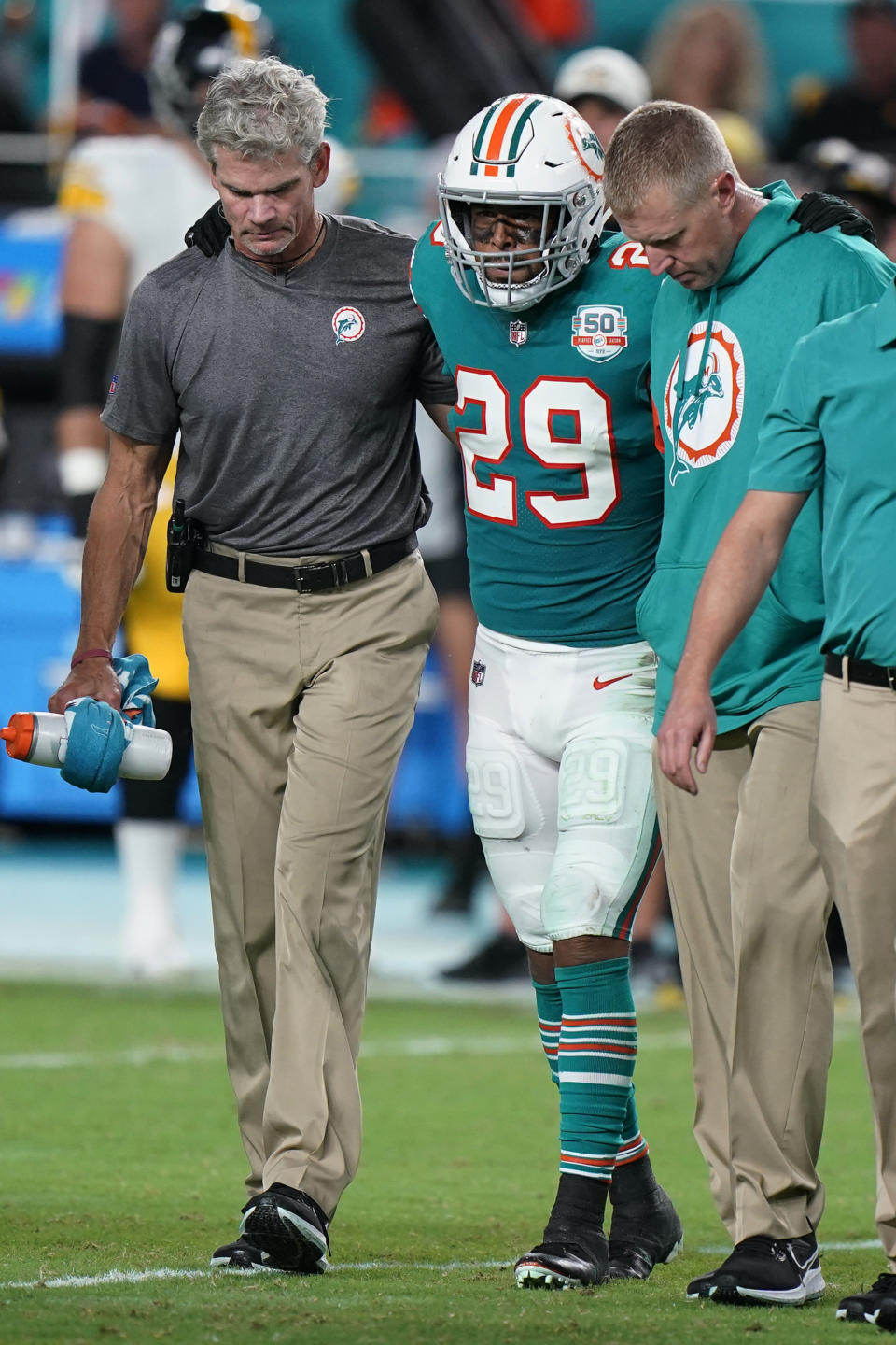 Miami Dolphins safety Brandon Jones (29) is assisted off the field during the second half of an NFL football game against the Pittsburgh Steelers, Sunday, Oct. 23, 2022, in Miami Gardens, Fla. (AP Photo/Wilfredo Lee )