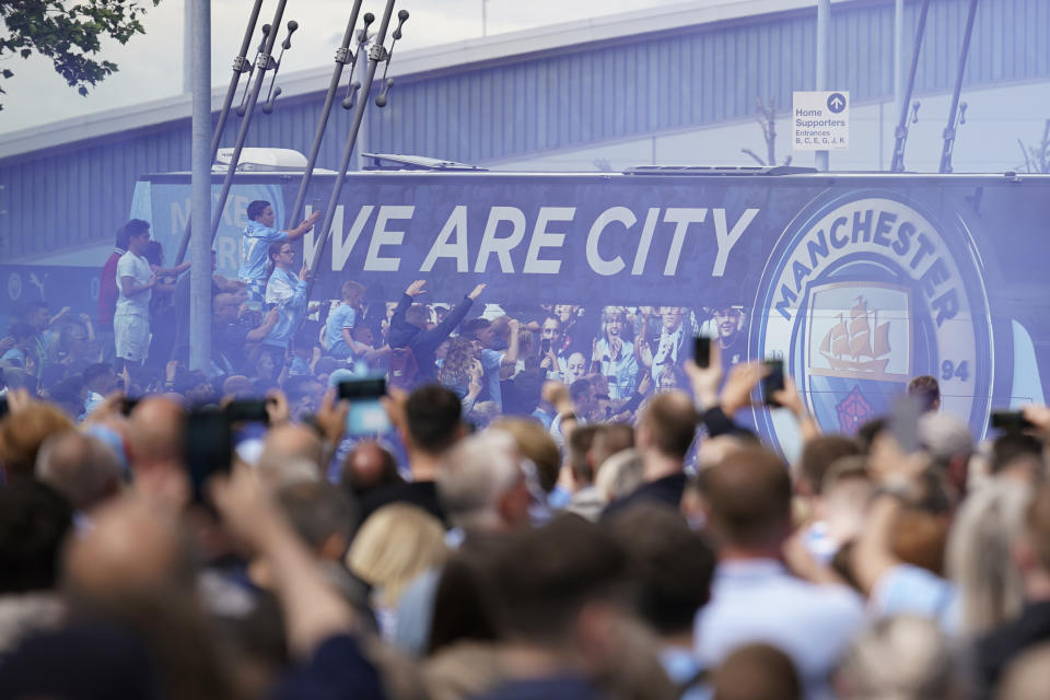 FILE - Fans welcome Manchester City players before the start of the English Premier League soccer match between Manchester City and Aston Villa at the Etihad Stadium in Manchester, England, Sunday, May 22, 2022. Manchester City has been accused of numerous breaches of the Premier League's financial regulations between 2009-18. The period covers the first nine full seasons under the club’s Abu Dhabi ownership. City won the league on three occasions during that time in 2012, 2014 and 2018. (AP Photo/Dave Thompson, File)