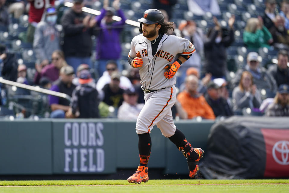 San Francisco Giants' Brandon Crawford circles the bases after hitting a two-run home run off Colorado Rockies starting pitcher Jon Gray in the second inning of a baseball game Wednesday, May 5, 2021, in Denver. (AP Photo/David Zalubowski)