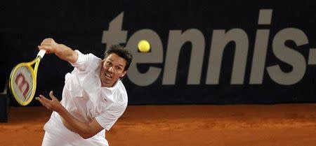 Germany's Michael Stich returns a ball during his German Open tennis doubles match with partner Mischa Zverev against Australia's Paul Hanley and Sweden's Simon Aspelin in the northern German city of Hamburg July 21, 2009. REUTERS/Morris Mac Matzen