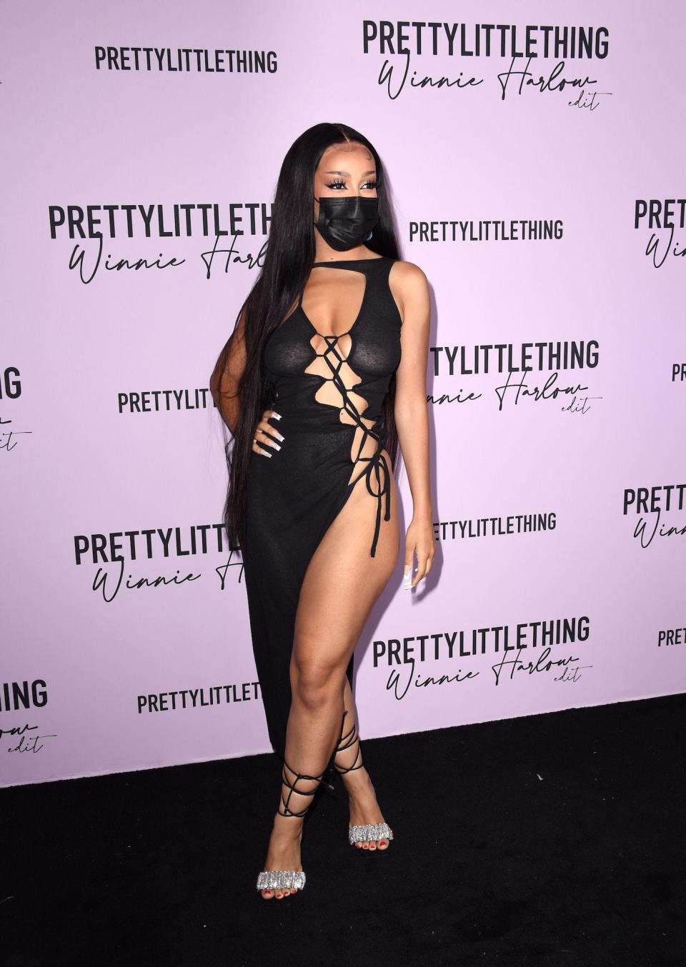 Doja Cat wears a mask and daring dress at a PLT x Winnie Harlow event in July 2021.