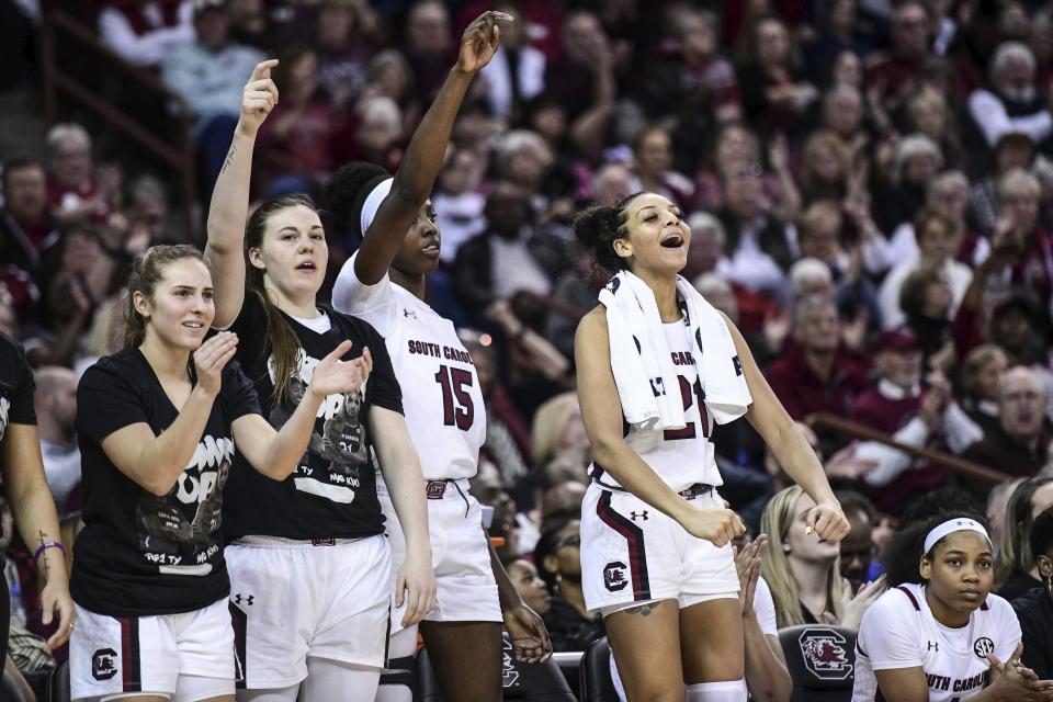 South Carolina forward Mikiah Herbert Harrigan, right, Laeticia Amihere (15), Elysa Wesolek and Olivia Thompson, left, react to a score during the second half of an NCAA college basketball game against Texas A&M, Sunday, March 1, 2020, in Columbia, S.C. (AP Photo/Sean Rayford)