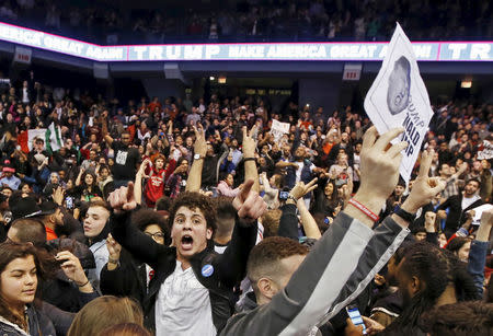 Demonstrators celebrate after Republican U.S. presidential candidate Donald Trump cancelled his rally at the University of Illinois in Chicago March 11, 2016. REUTERS/Kamil Krzaczynski