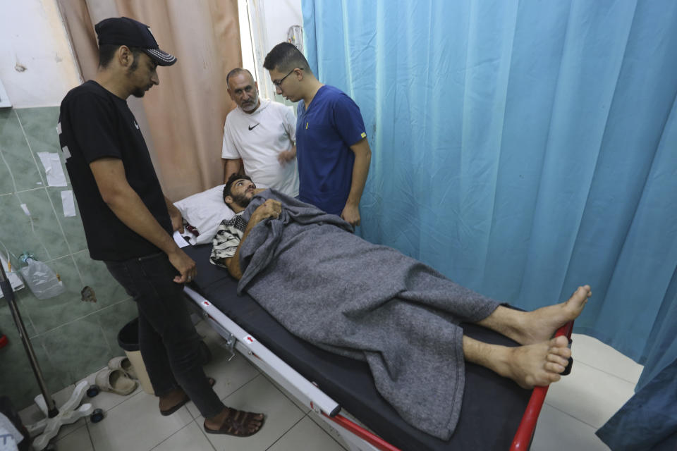 A Palestinian wounded in the Israeli bombardment of the Gaza Strip waits for treatment in a hospital in Rafah on Saturday, Oct. 28, 2023. (AP Photo/Hatem Ali)