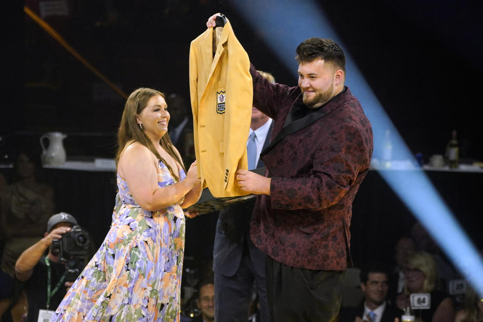 Connor, right, and Shannon McNally accept the gold jacket for their grandfather Art McNally, during the gold jacket dinner for the Pro Football Hall of Fame in Canton, Ohio, Friday, Aug. 5, 2022. (AP Photo/Gene J. Puskar)