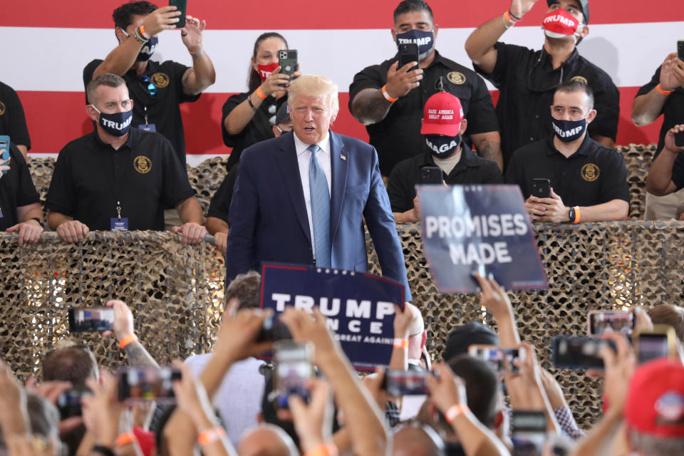 YUMA, AZ - AUGUST 18: U.S. President Donald Trump attends a campaign rally at The Defense Contractor Complex on August 18, 2020 in Yuma, Arizona. Trump excoriated presumptive Democratic nominee former Vice President Joe Biden as being soft on illegal immigration as Democrats hold their convention this week remotely from Milwaukee. Hundreds waited in line in 104-degree heat to see the president, many without masks or maintaining distance from others, according to published reports. The crowd size inside the hangar was limited in a nod to the ongoing pandemic that has hit Yuma County particularly hard.  (Photo by Sandy Huffaker/Getty Images)