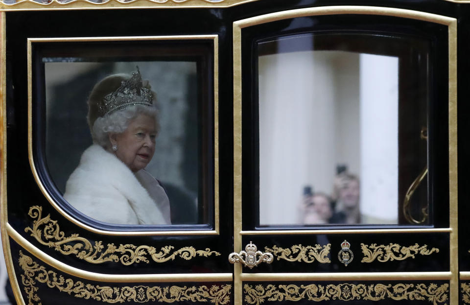 Britain's Queen Elizabeth II travels in a carriage to parliament for the official State Opening of Parliament in London, Monday, Oct. 14, 2019. (AP Photo/Frank Augstein)