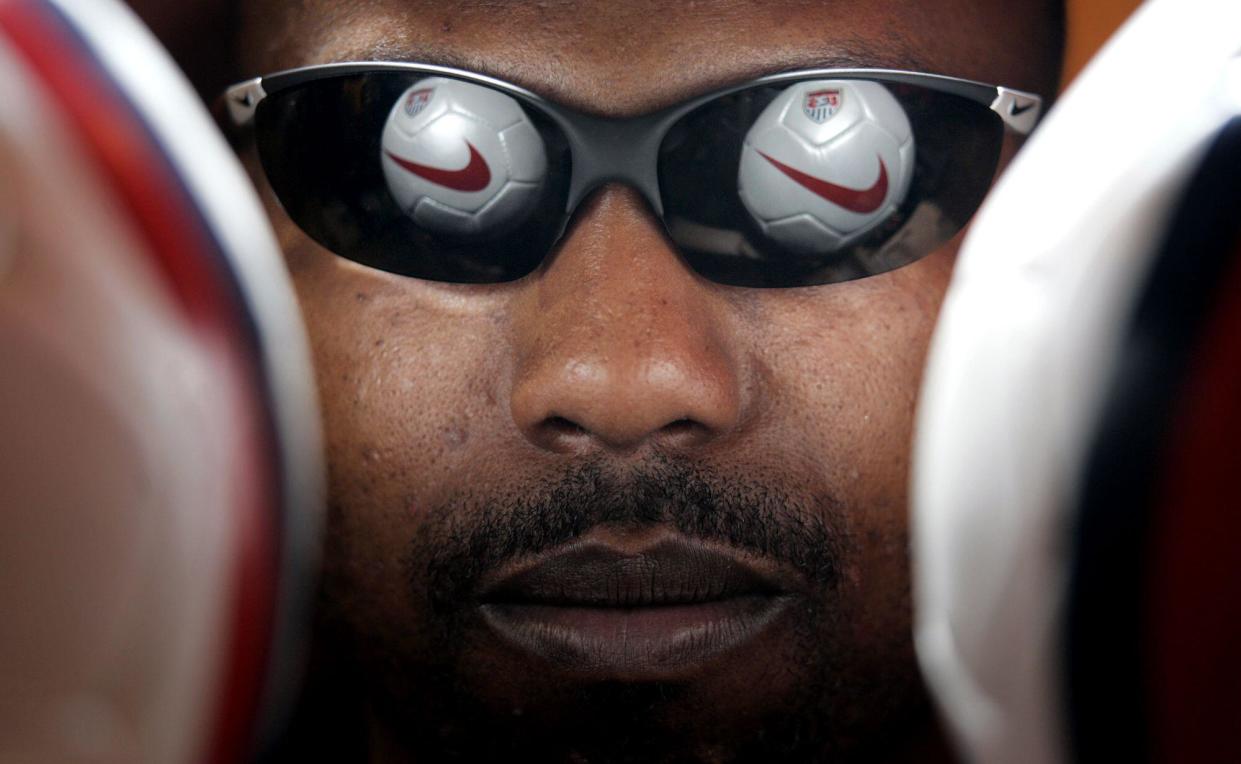 Nike soccer balls are reflected off a pair of glasses at Niketown in Portland, Oregon, US. 